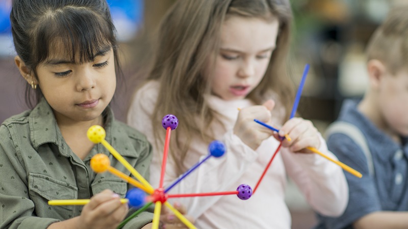 Early care in Billings, young children with tinker toys, 2 column