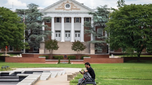student sitting in an empty campus