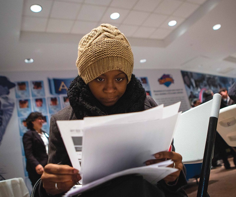 Woman reading papers at a job fair