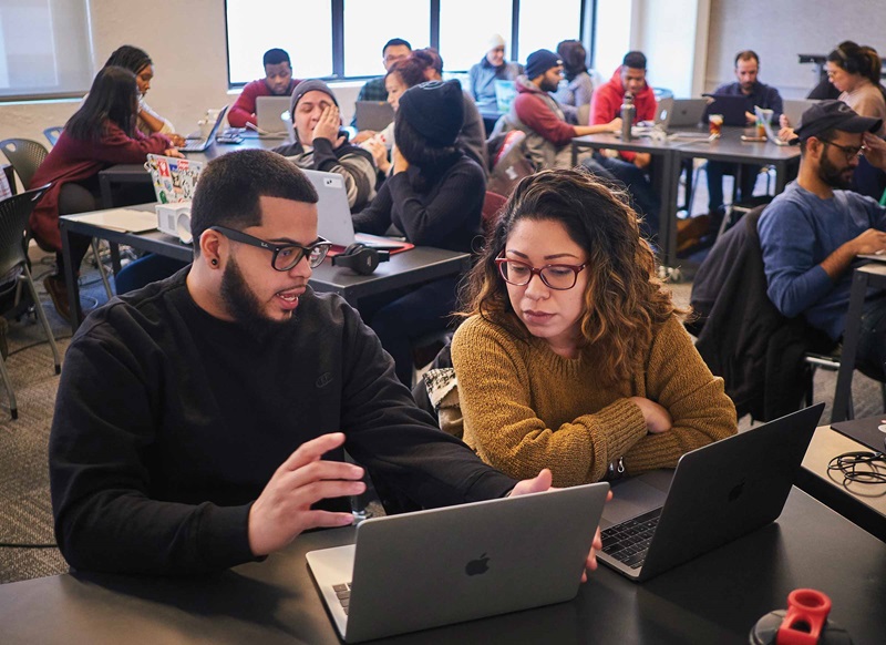 Two adults collaborating