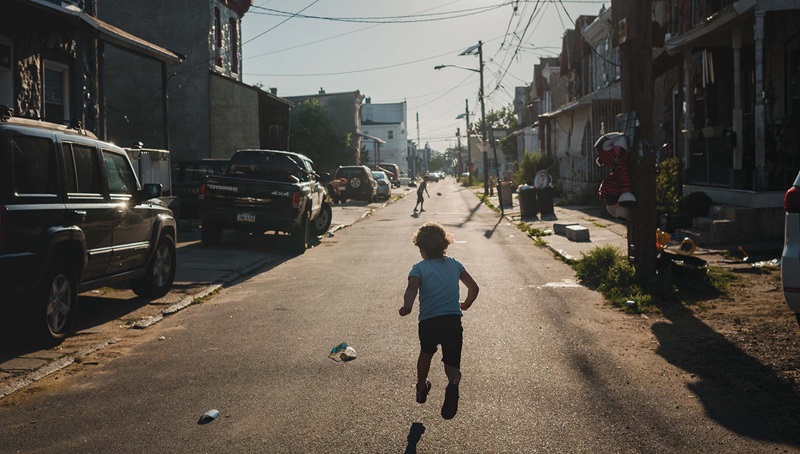 Child running through city