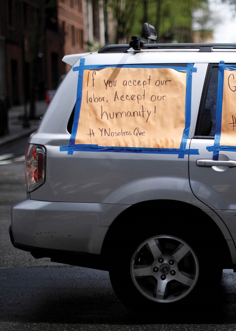 An SUV with protest signs for workers rights