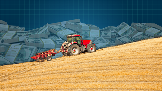 Tractor moving up a hill, money silhouetted in the background