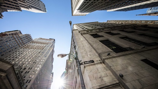Looking up at Wall Street buildings