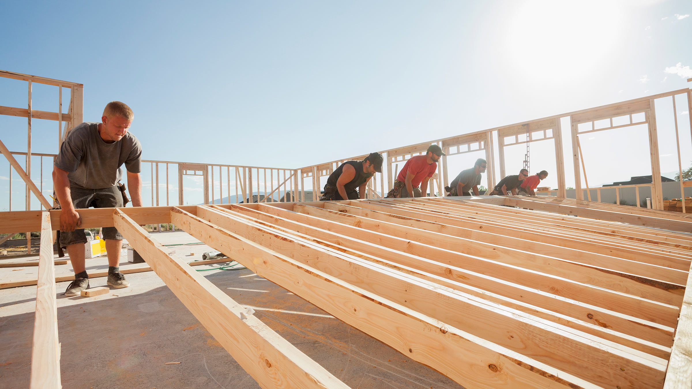 A group of workers framing a building