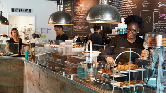 A group of employees working behind the counter at a locally-owned coffee shop