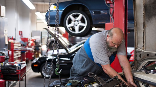 Mechanic working on a vehicle in a repair shop