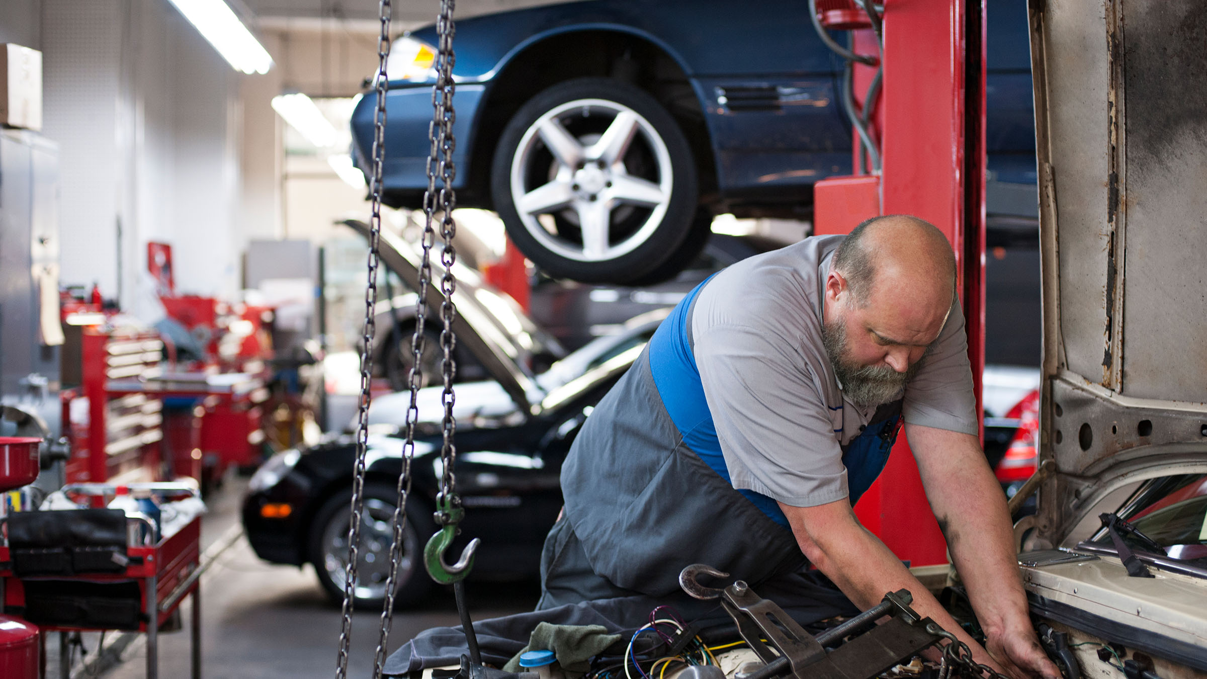 Mechanic working on a vehicle in a repair shop