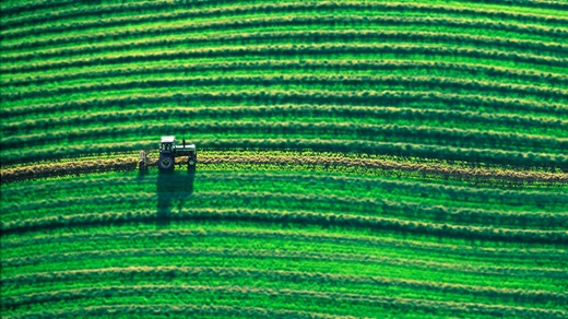 Tractor driving through a farm field