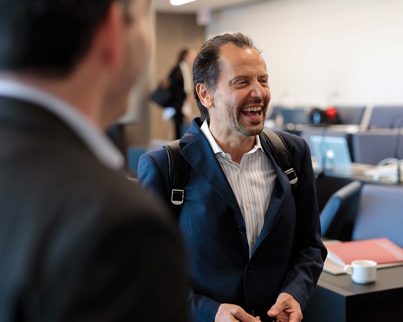 Luigi Zingales laughing in conversation