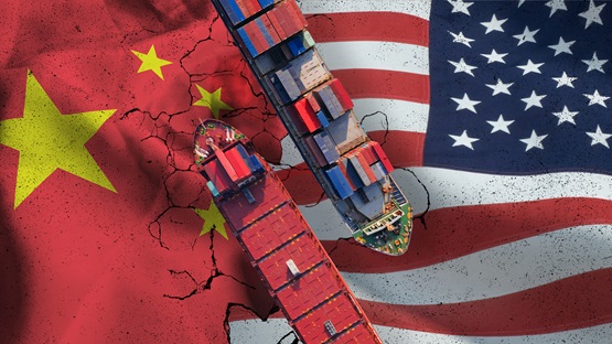 Container ships passing by each other transposed over Chinese and American flags