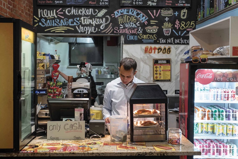 Person working the counter at a restaurant