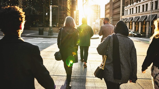 Workers walking home through a city in the evening