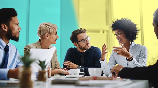 Diverse group of workers having a discussion at a table