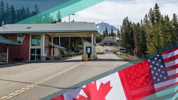 A rural U.S.-Canada border crossing in Montana with an image of a Canadian and U.S. flag in the lower right corner