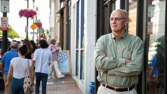 David Wilcox standing on a busy sidewalk