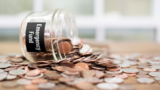 Change jar labelled "emergency fund" spilled onto a table