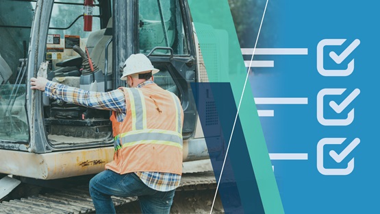 Construction worker climbing into the cab of construction equipment at a job site