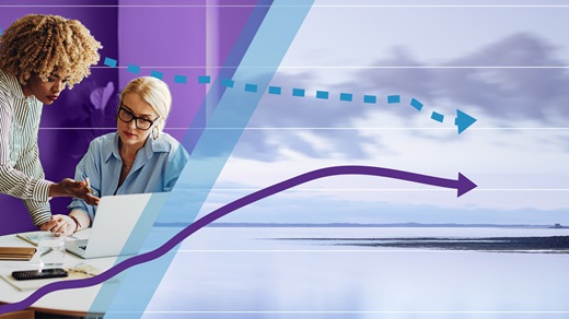 Two female colleagues meeting in an office on the left beside an image of tranquil lake scene with a graph spanning the whole image. 