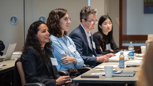 Photo of four people attending an Institute conference