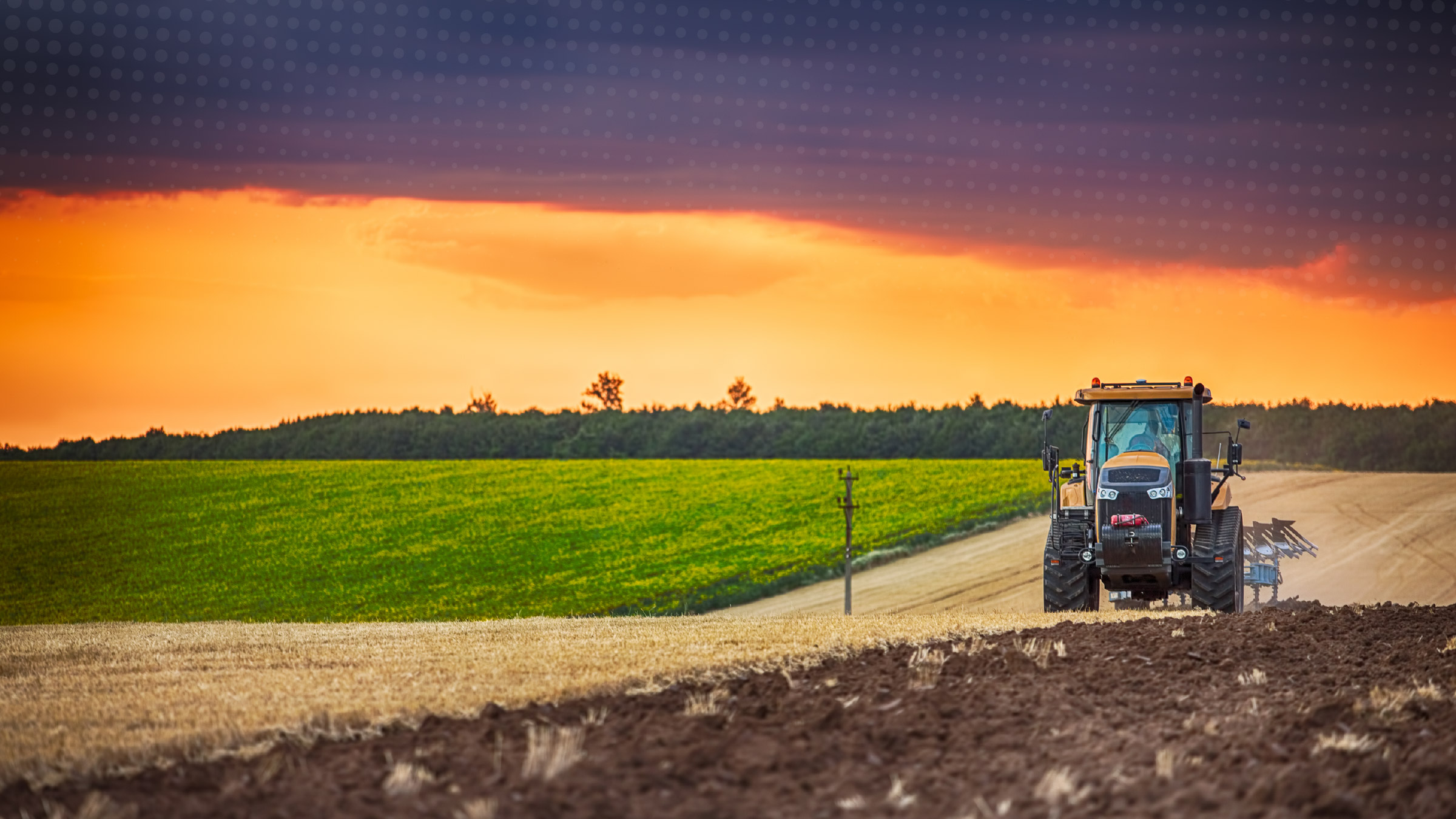 Tractor tilling a field, preparing for planting