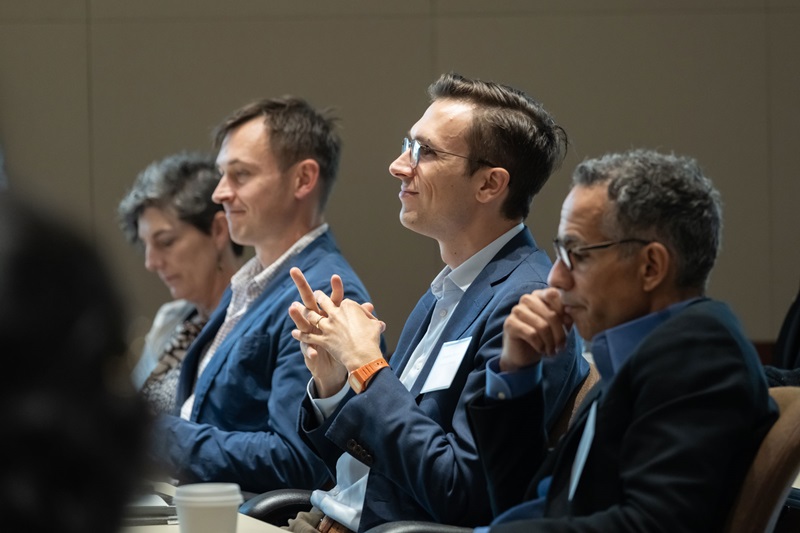 Audience members listening to a presentation