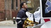 A paramedic loading a patient into an ambulance
