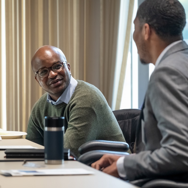 Four panelists on stage during a presentation