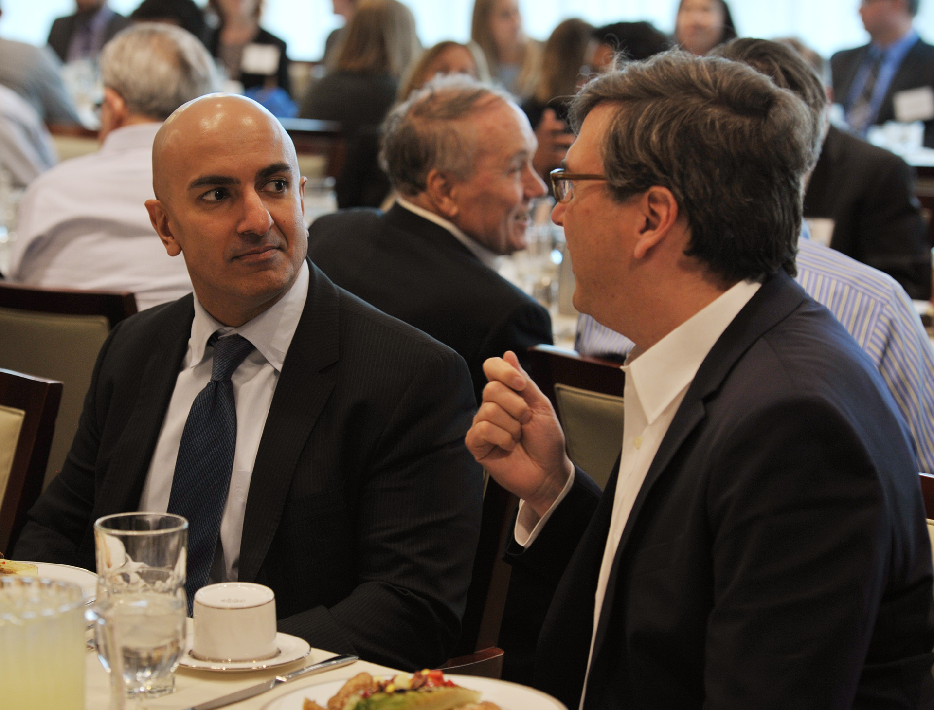 Kashkari and Furman speaking together at lunch