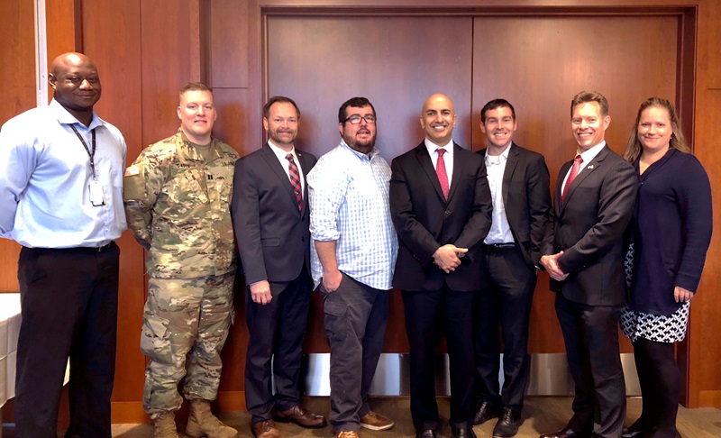 Photo of Neel Kashkari and veterans