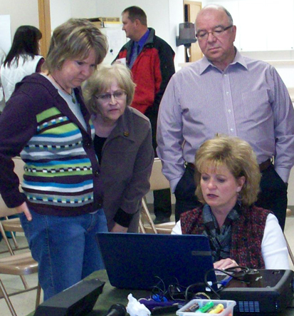 During a strategy session led by Dakota Resources, residents of Lemmon, S.D., consult with the organization's program developer, Kristi Wagner (seated).