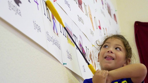 A child learns her letters at Lakota Immersion Childcare