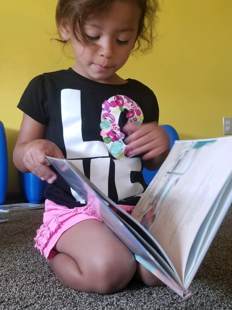 ECD in Indian Country, preschool girl reading, 2 column