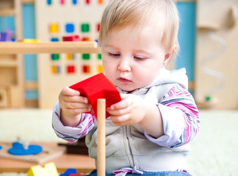 Pay for Success for ECD, baby with toy
