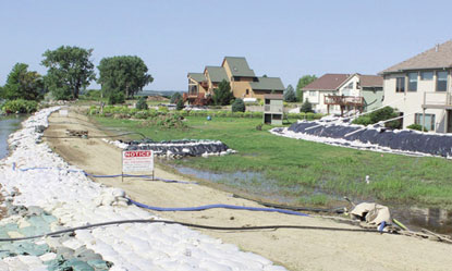 Multiple pump hoses carry groundwater over a dike in rural Union County, S.D.