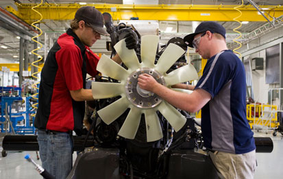 Workers readying an engine at the AGCO plant in Jackson, Minn.