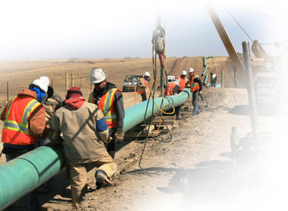 Construction crews under contract for WBI Energy lay a natural gas pipeline near Williston, N.D.
