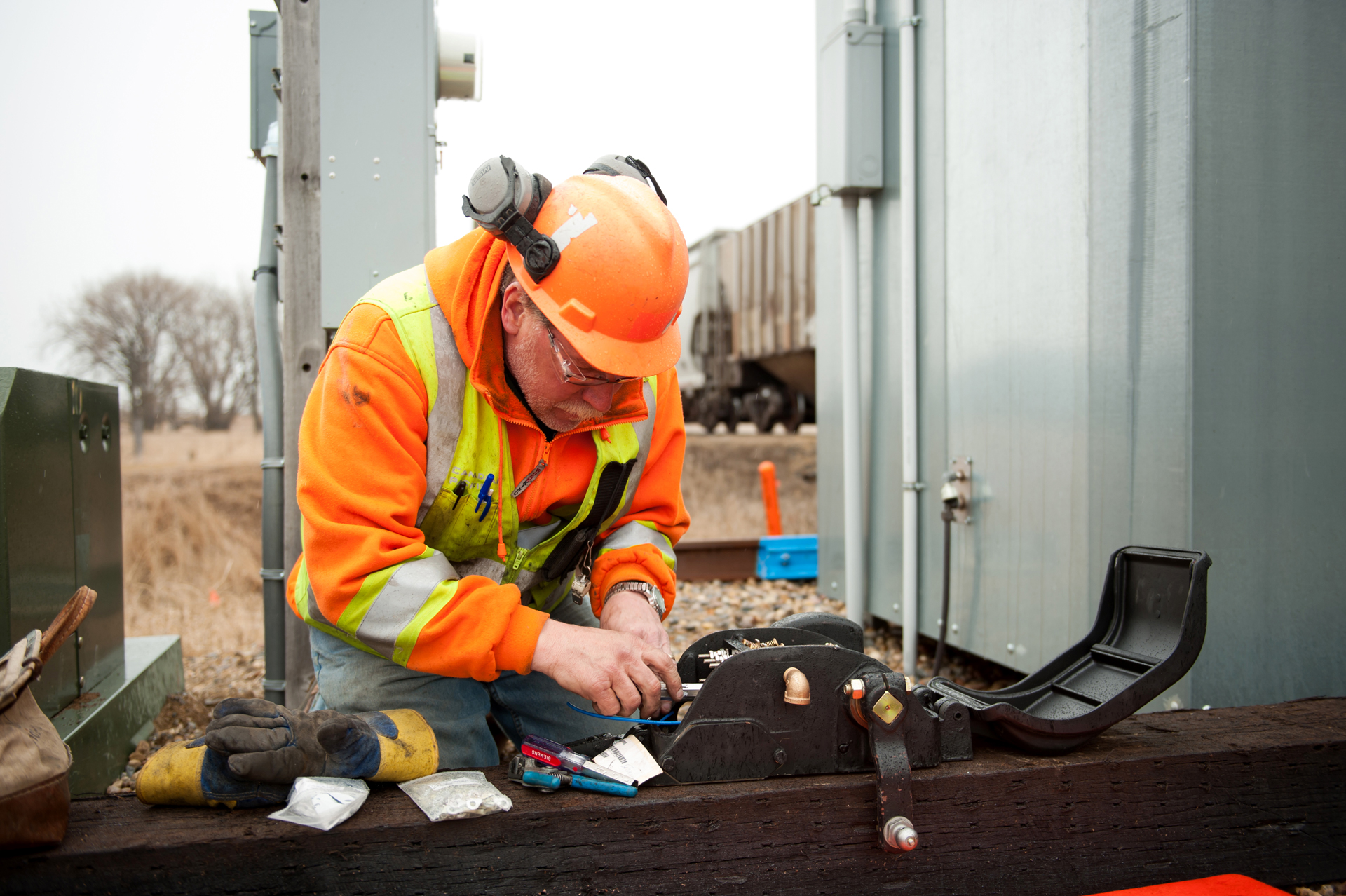 Canadian Pacific assistant signalman Mark Hasen wires a switch circuit controller as part of the installation of centralized traffic control near Hankinson, N.D.