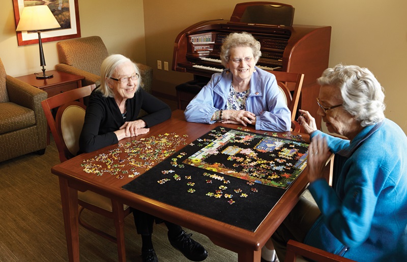 Verna Olson, Grace Neumann and Patricia Lysen socialize at Minnehaha Senior Living in Minneapolis.