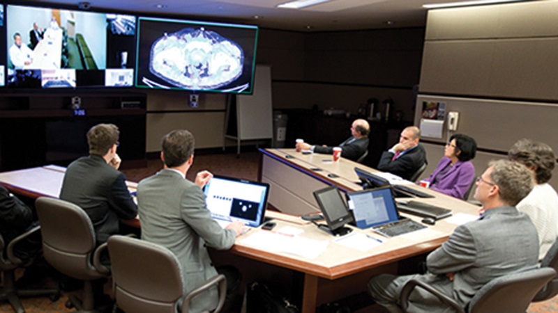Mayo’s eTumor Board members consult with providers onscreen about an oncology case through the subscriber-based Mayo Clinic Care Network.