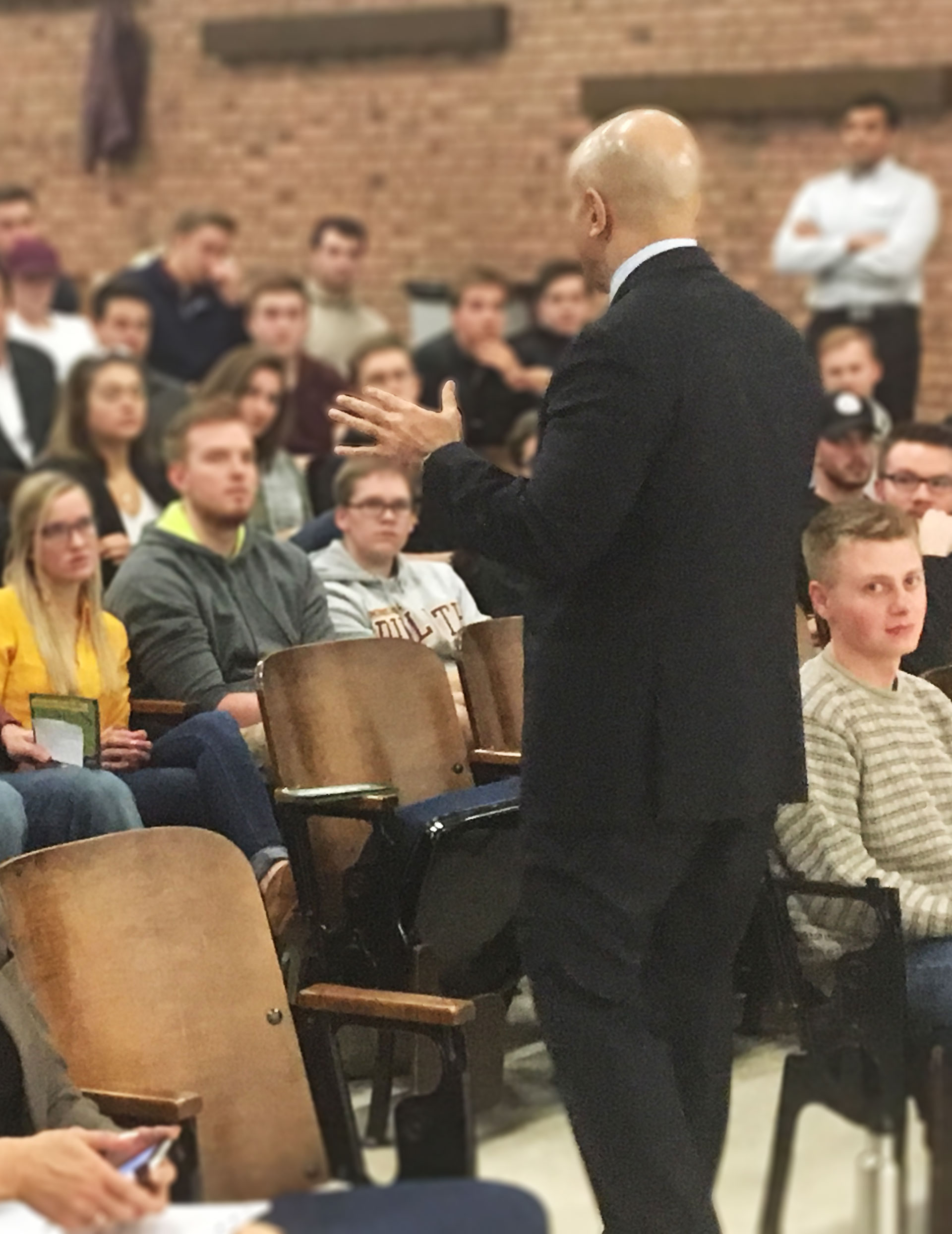 Neel Kashkari speaking to a lecture hall of students