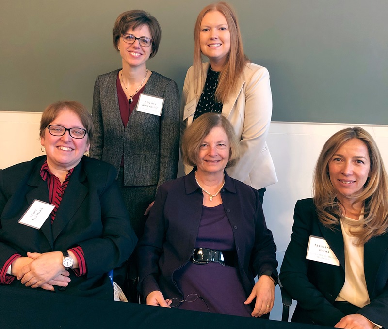 Photo of Minneapolis Fed senior counsel Melissa Rosenbaum and attorney Meredith Blee (standing) and presenters Marie Failinger, June Carbone, and Alessandra Fogli (L-R)