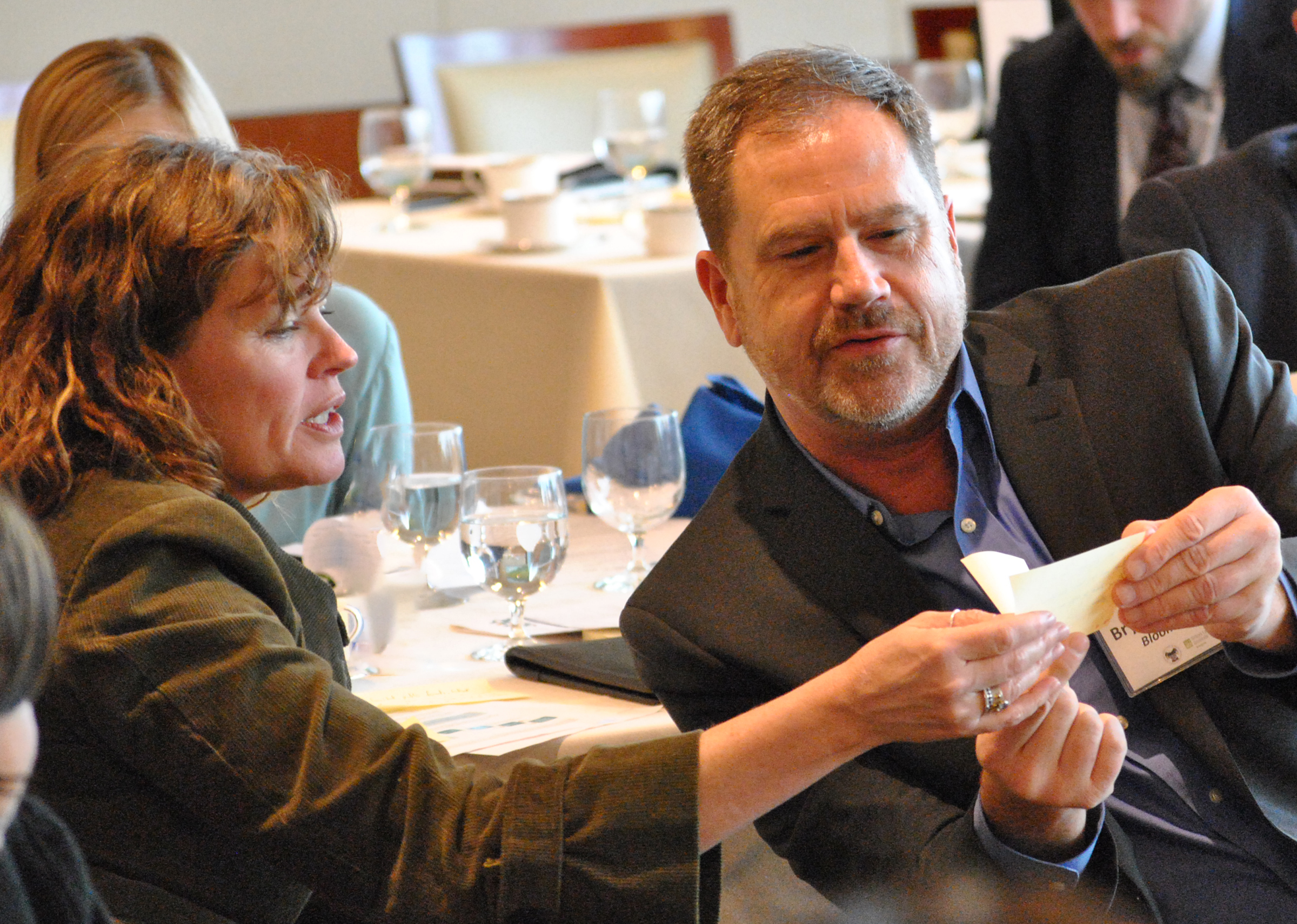 Participants at the peer learning event on mixed-income housing compare notes as they prepare to share their thoughts with the group