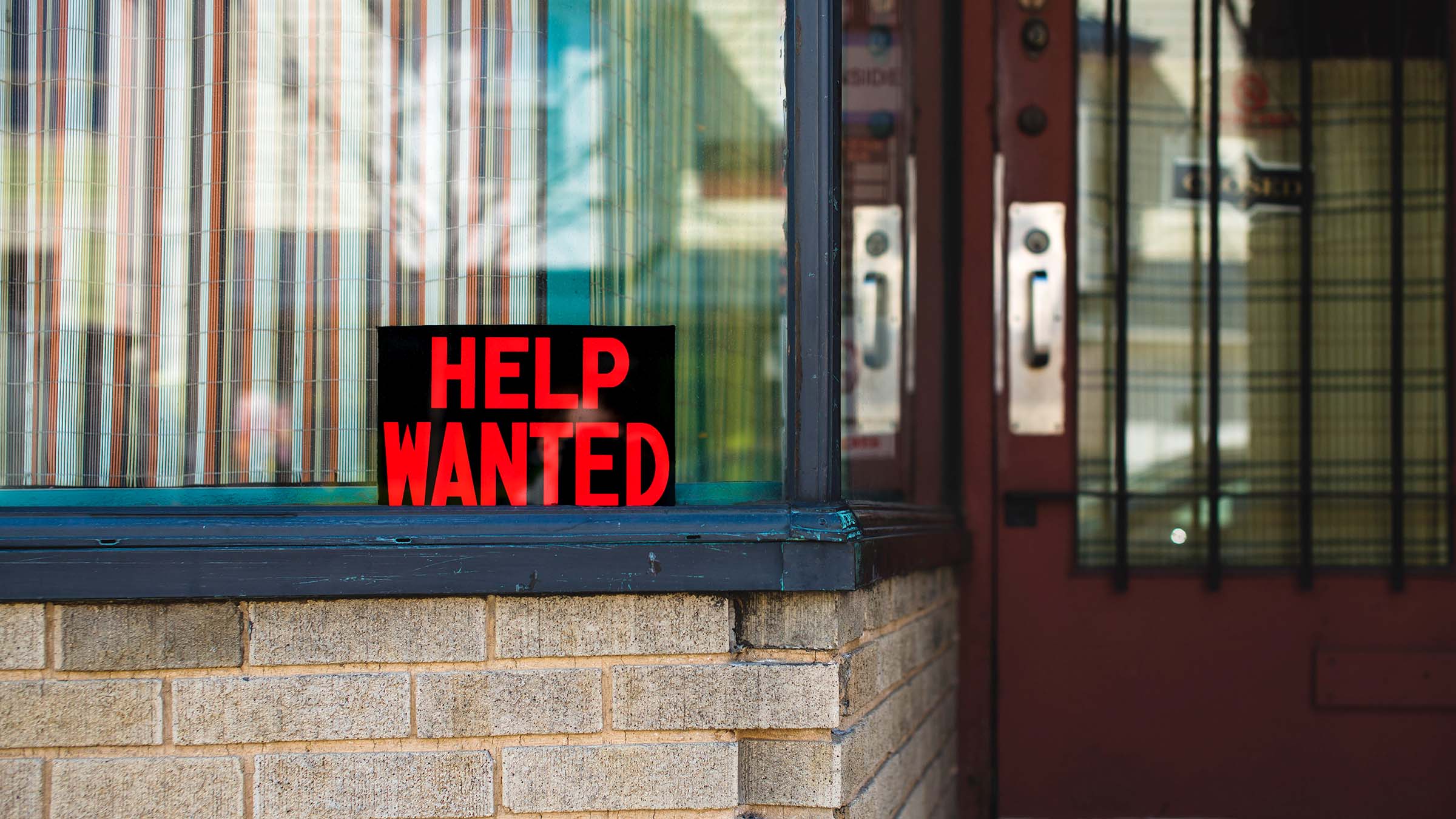 Help wanted sign in a store window