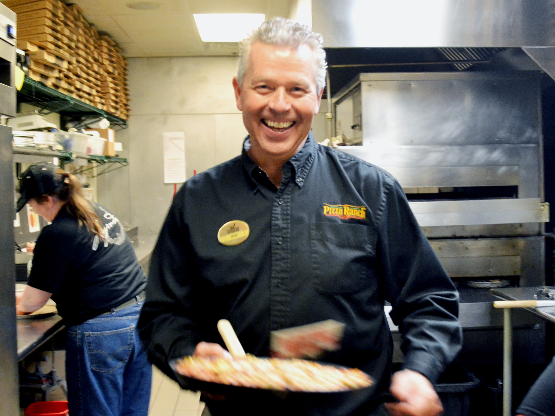Photo of Rob McDonald holding a pizza