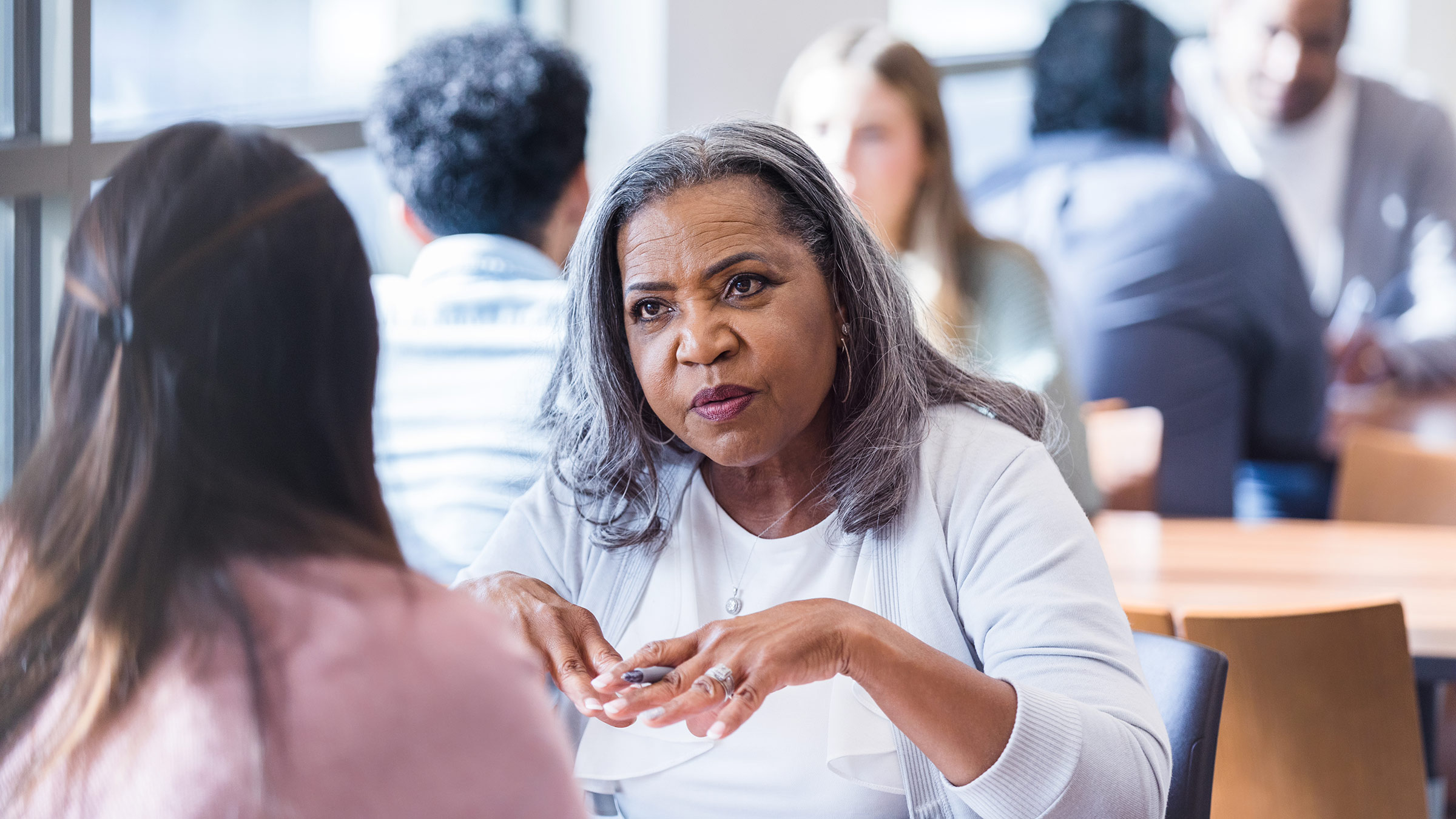 A female employer sits across a table from a potential job applicant