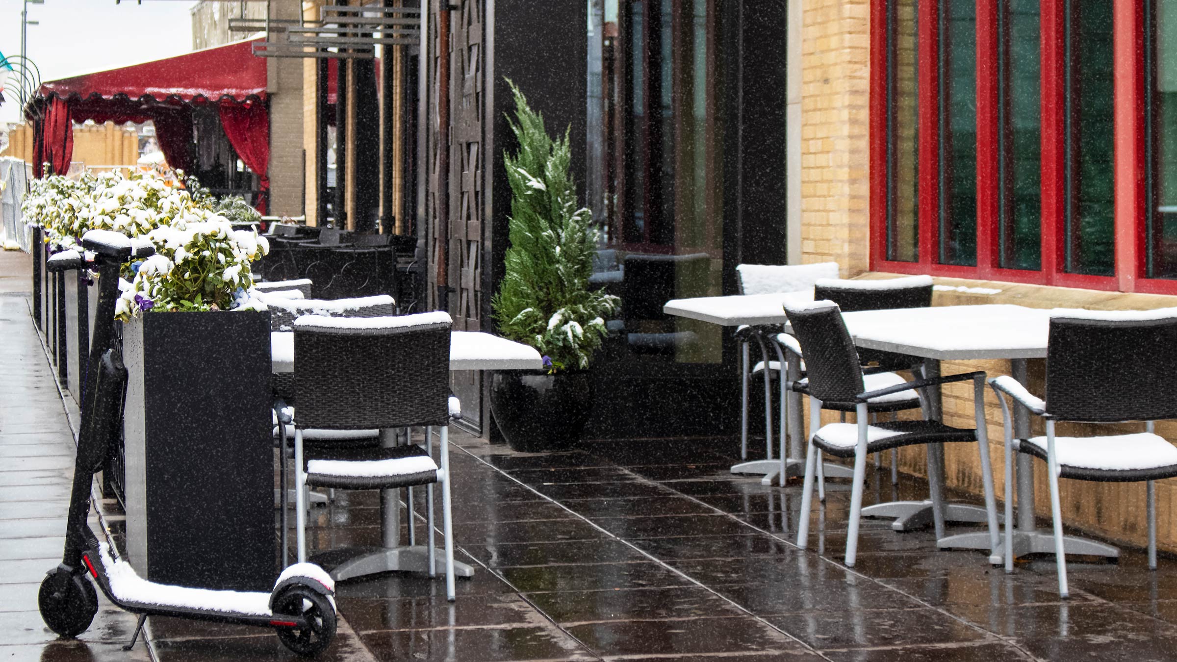 Snow covered patio dining area outside of an urban restaurant