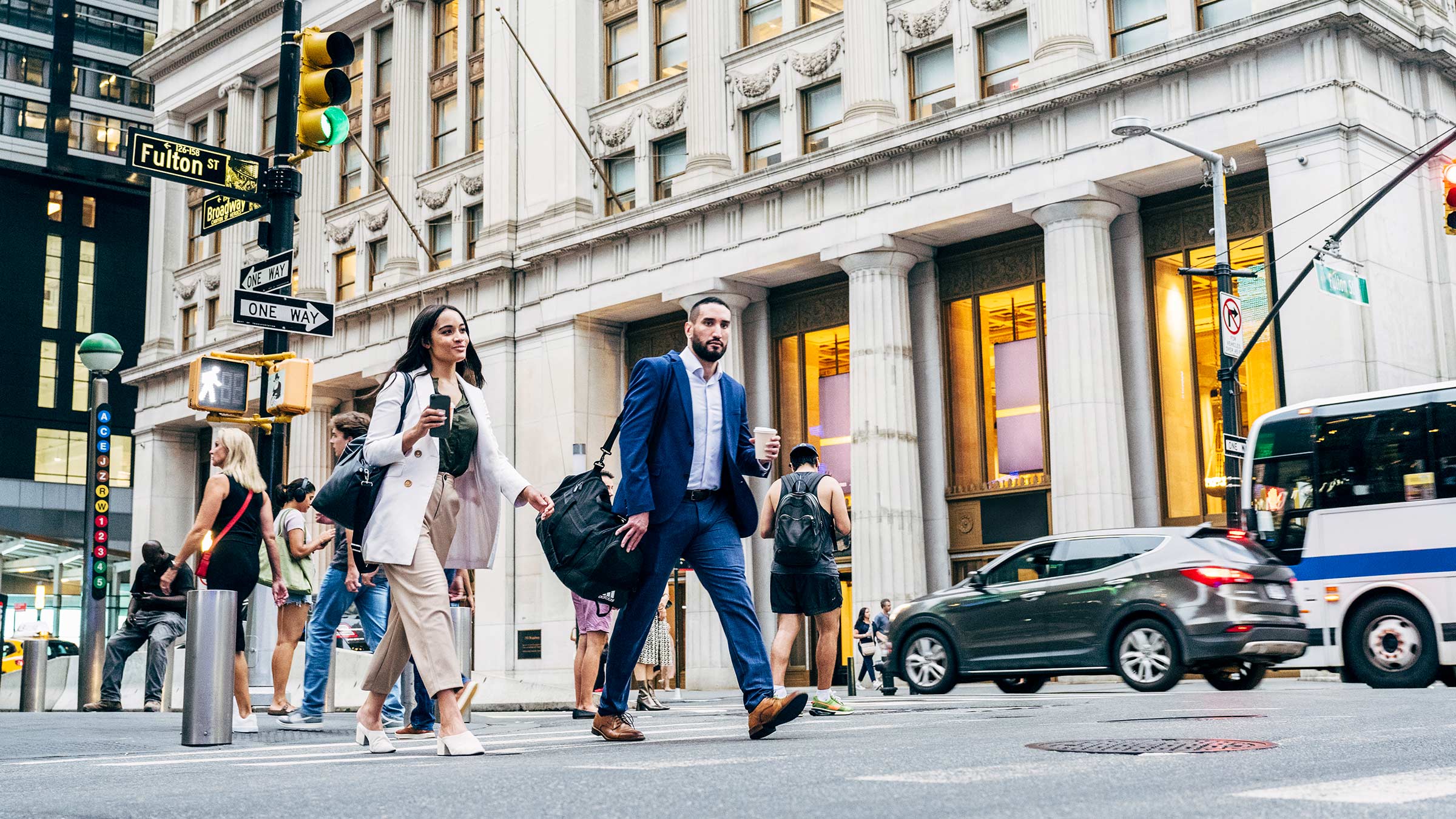Professionals walking through a busy city on their way to work